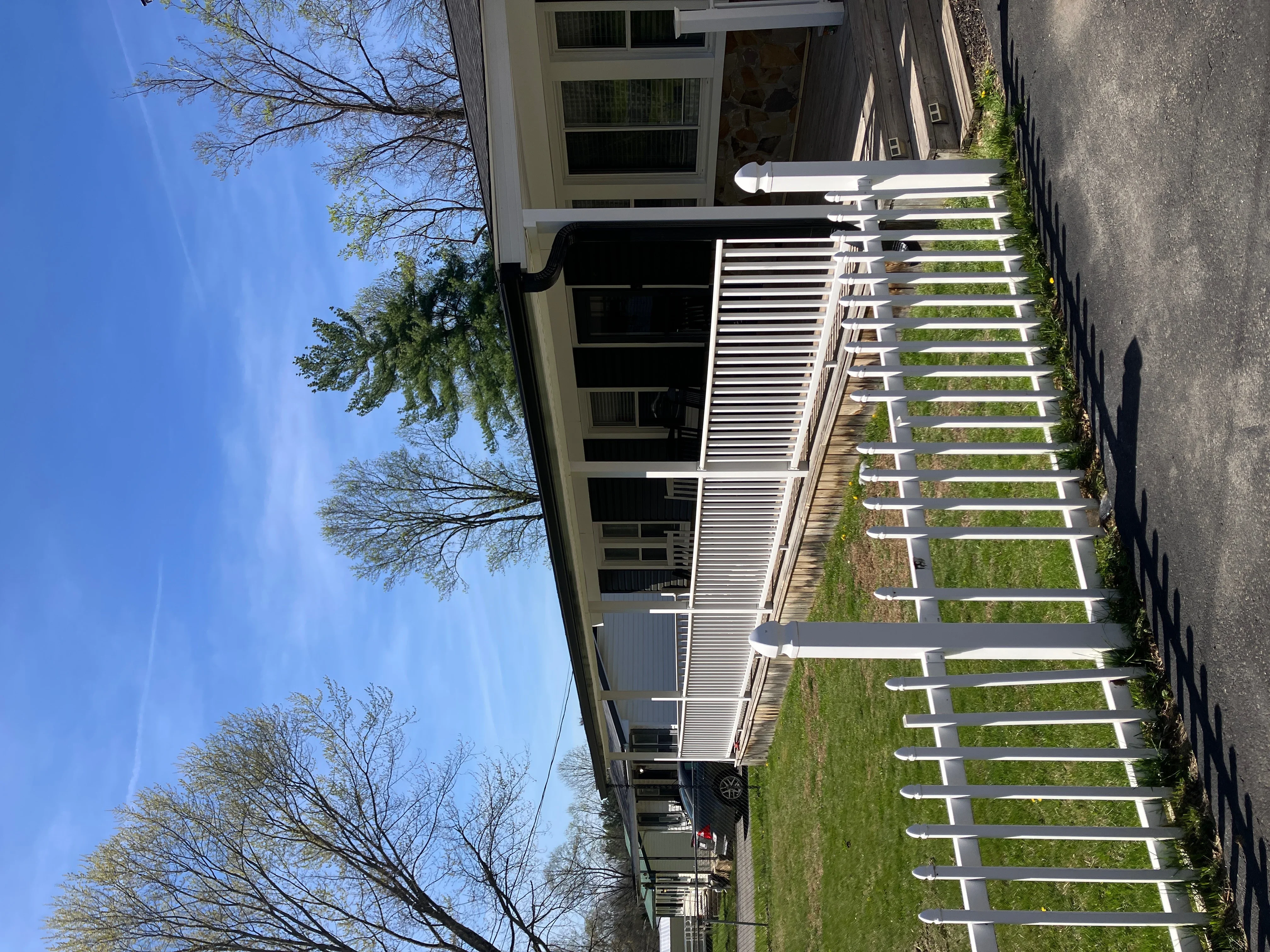 White aluminum gutters with guards installed on residential home roofline
